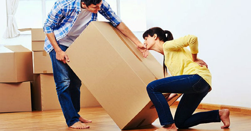 Women hurt while carrying a heavy cardboard box