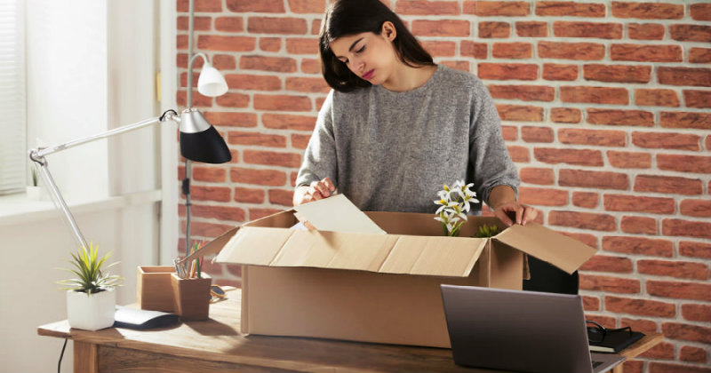 young beautiful woman packing things in a box