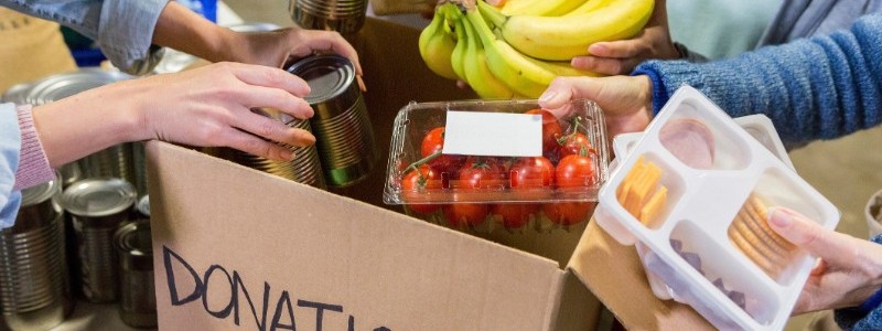 packing food supplies in a card box for donating