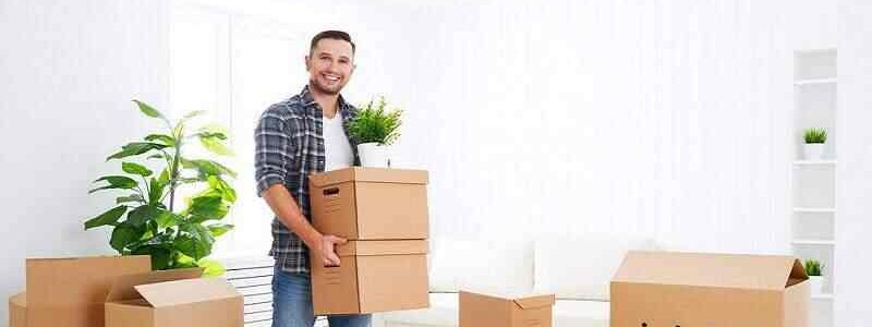 young man holding a couple of cardboard boxes