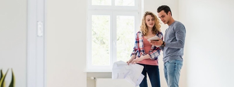 young couple inspecting a new house