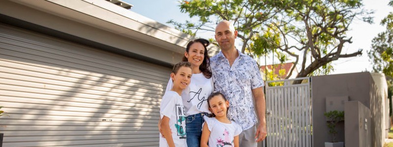 entire family standing outside of their garage