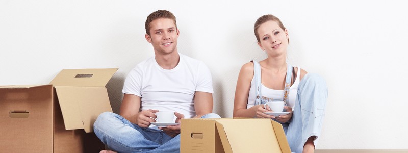 young couple sitting on the floor and enjoying their tea