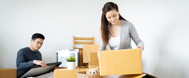 young couple packing household for relocation