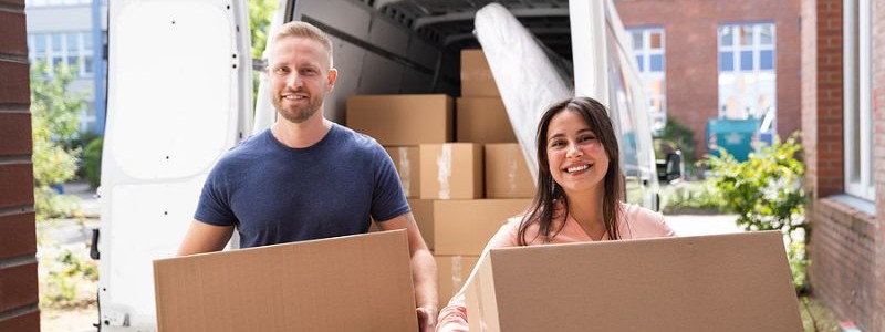young couple with cardboard boxes preparing for a household relocation