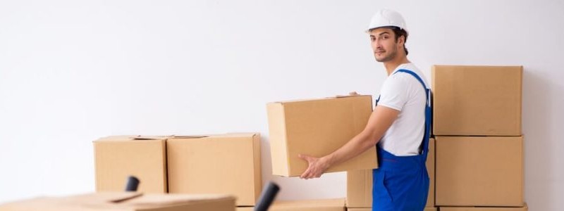 young professional lifting a cardboard box