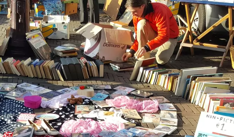 woman checking some books on a sale