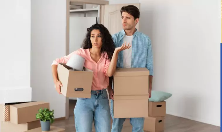 couple looking stressed inside of their new house