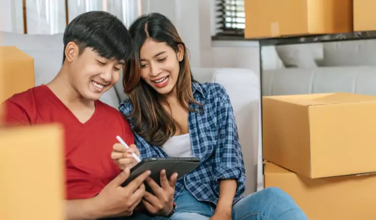 couple working on a tablet while sitting on the floor
