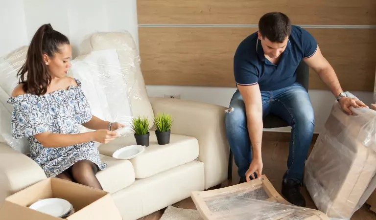 couple packing up household and sitting on a couch