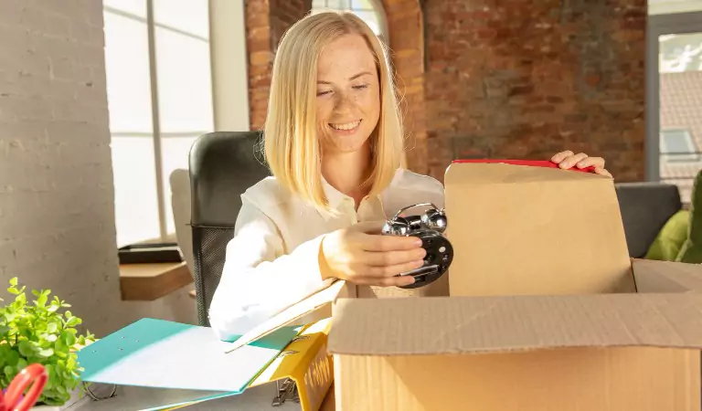 woman packing her belongings into a box