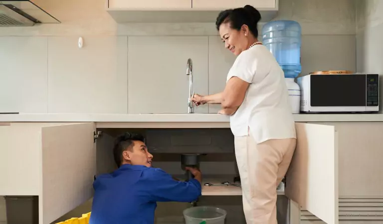 young professional trying to fix a drain