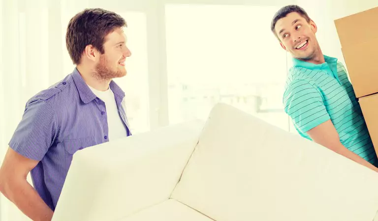 young boys lifting heavy furniture