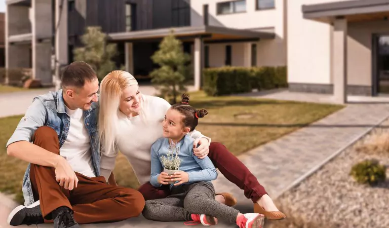 family sitting outside of their house