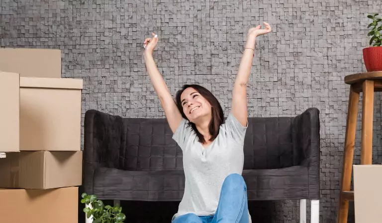 young woman inside of a new house looking happy