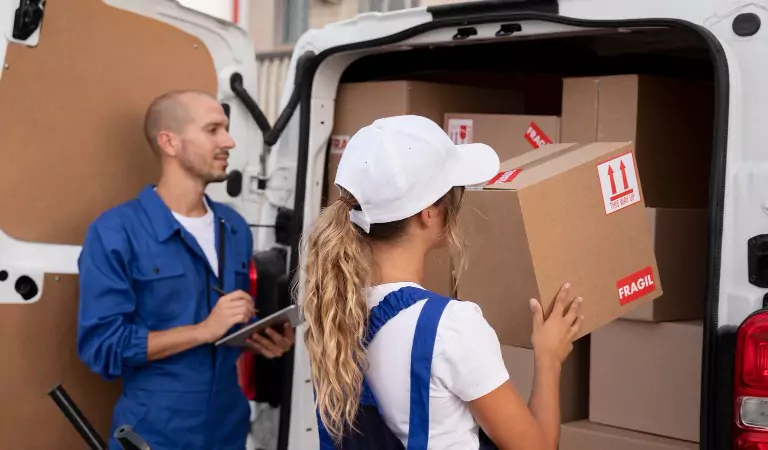 young professionals loading a van with some cardboard boxes