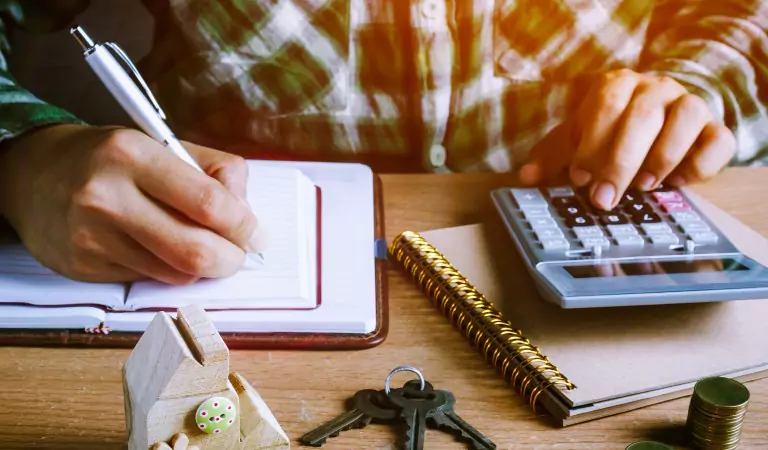 young man calculating something on a calculator