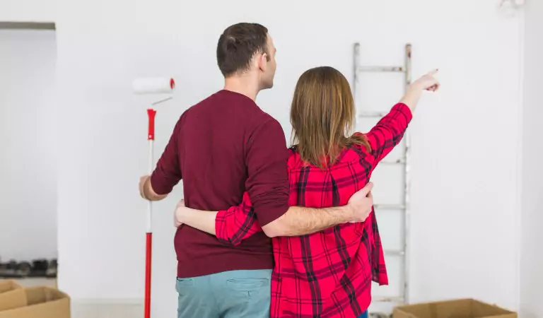 couple inside of their new house planning for renovation