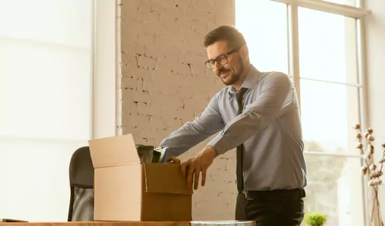 young man packing up a cardboard box