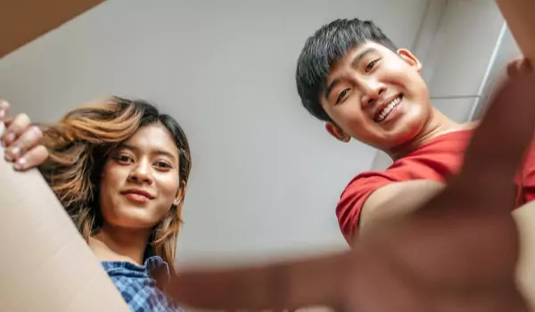 couple packig up a cardboard box