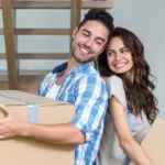 couple with cardboard boxes during a move