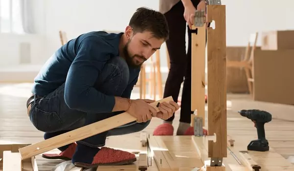 young man dismentling a furniture item