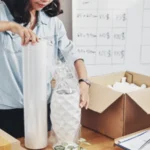 Woman packing something in box