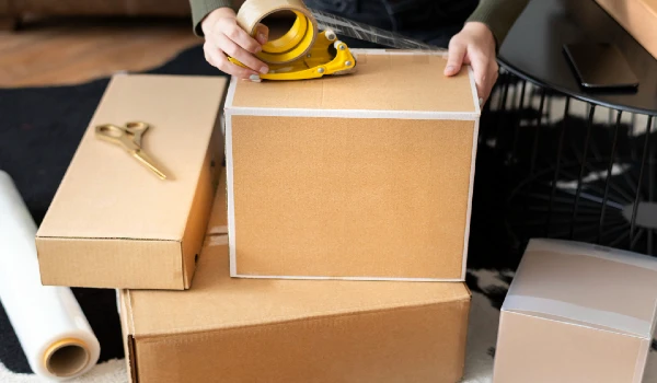 someone packing a box professionally